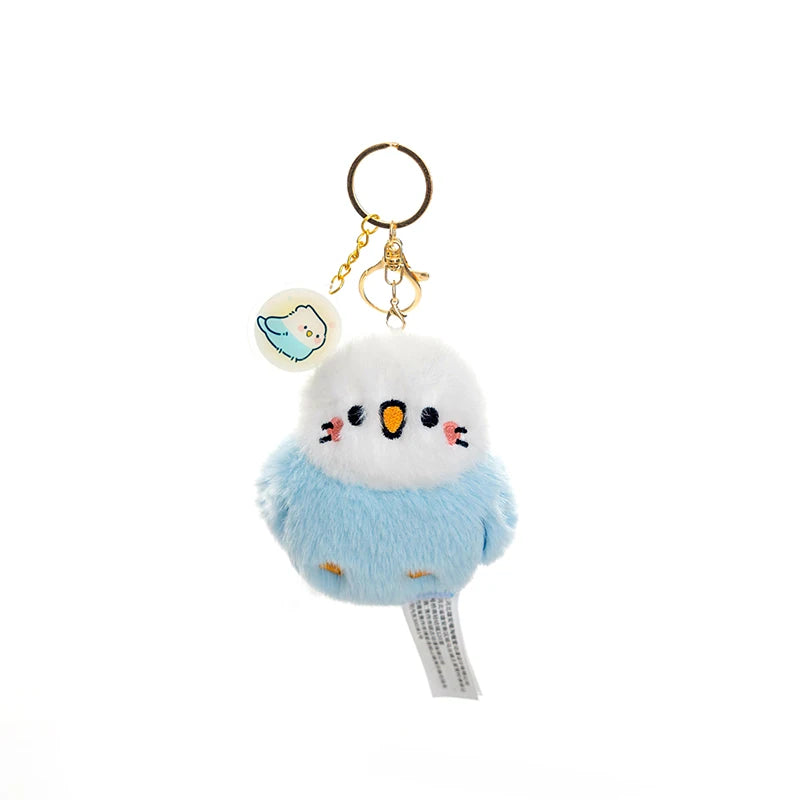 kawaii blue and white bird plushie keychain on a white background