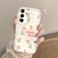 Phone case with bunny and tulip design held by a hand against a neutral background