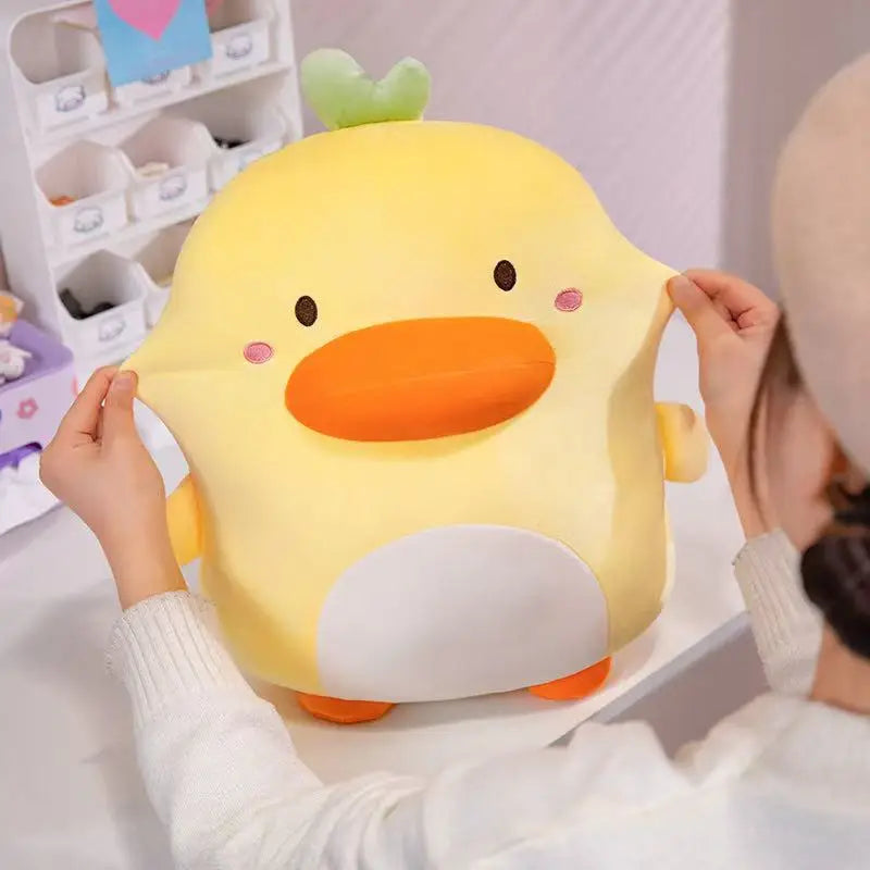 A women squishing the cheeks of the Kawaii Derpy Duck Plushie