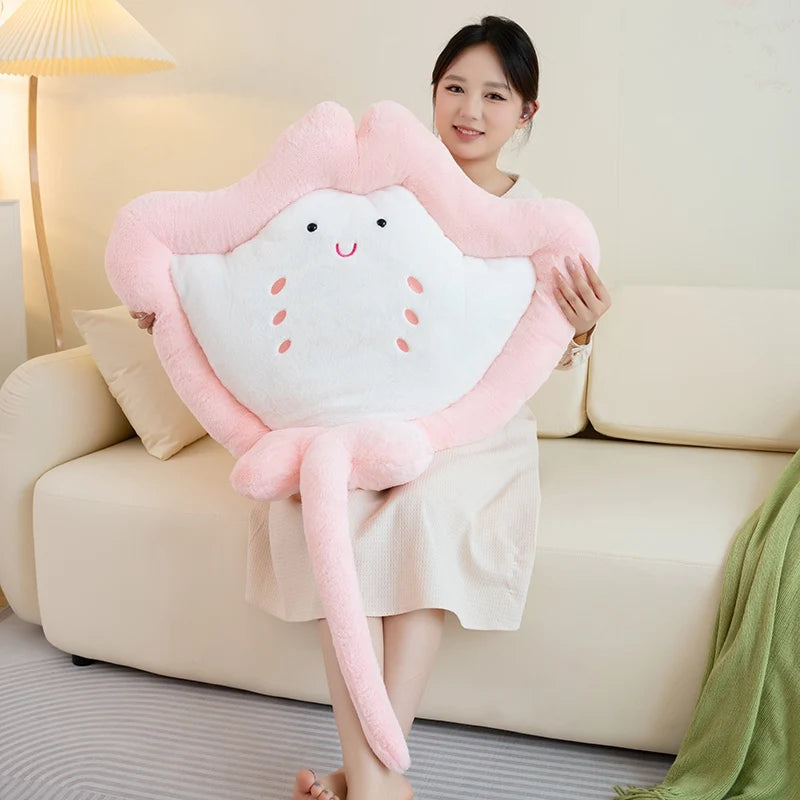Woman holding Kawaii manta ray plushie