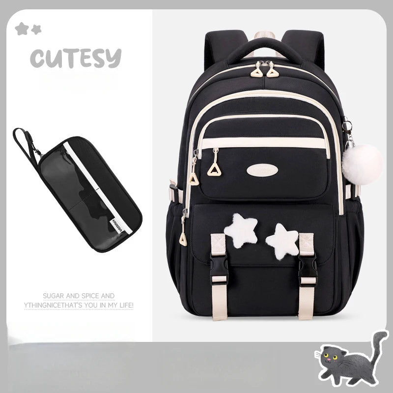Black backpack with star designs and a small black pouch on a light gray background.