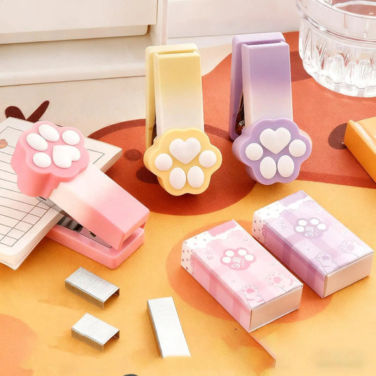 Kawaii Pastel Cat Paw Stapler, this image is showing the different colors you can get of the cat paw stapler which include pink, purple and yellow.