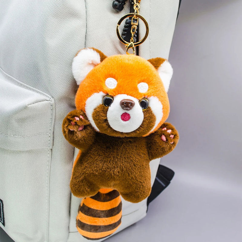 Kawaii Red Panda Plushie Pendant Keychain displayed on the side of a white bag