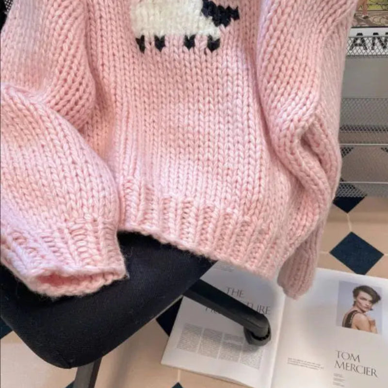 Kawaii Little Lamb Sweater displayed on a chair in an office 