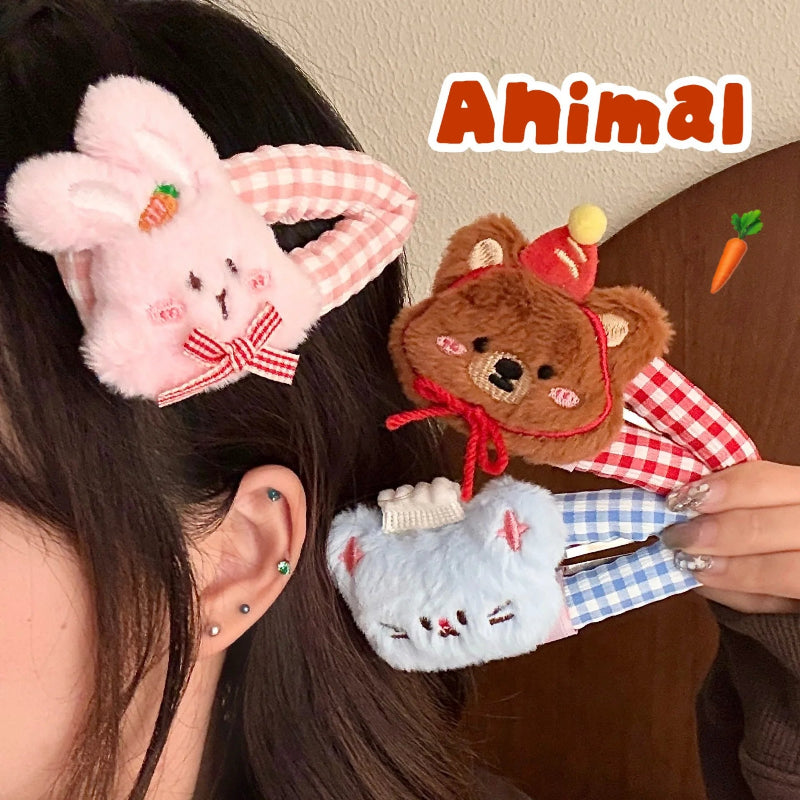Person wearing a pink bunny hair clip and holdinea brown bear and blue mouse hair clips