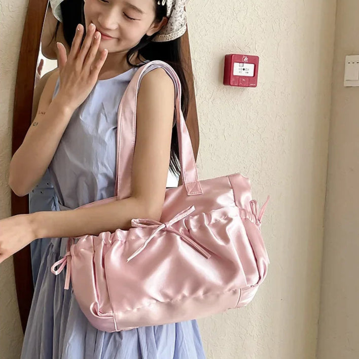 Woman holding a pink satin bag indoors