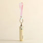 Small handheld bear fan with a keychain on a beige background