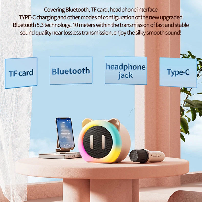 Cute Cat Mini Karaoke Speaker pink edition displayed on a pink table top with a microphone and phone next to it. this image is also explaining that it has a Bluetooth multi mode.