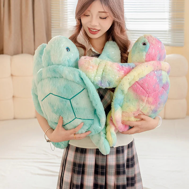 Plush blue and pastel turtles being held by a woman