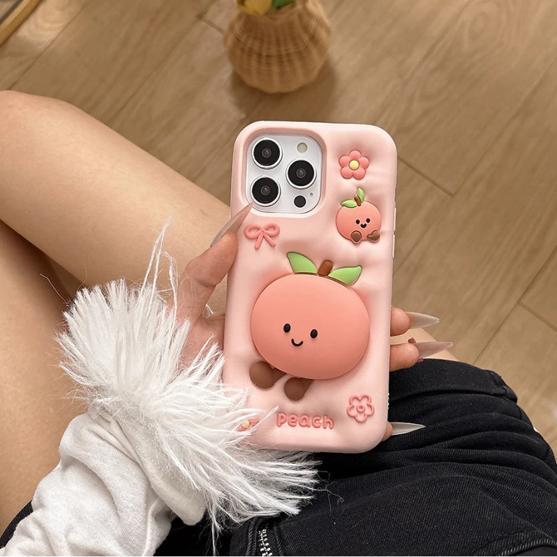 Rear view of Kawaii Peach iPhone Case held by a woman. 