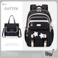 Black backpack with star designs and a matching handbag on a light gray background, branded 'CUTESY'.
