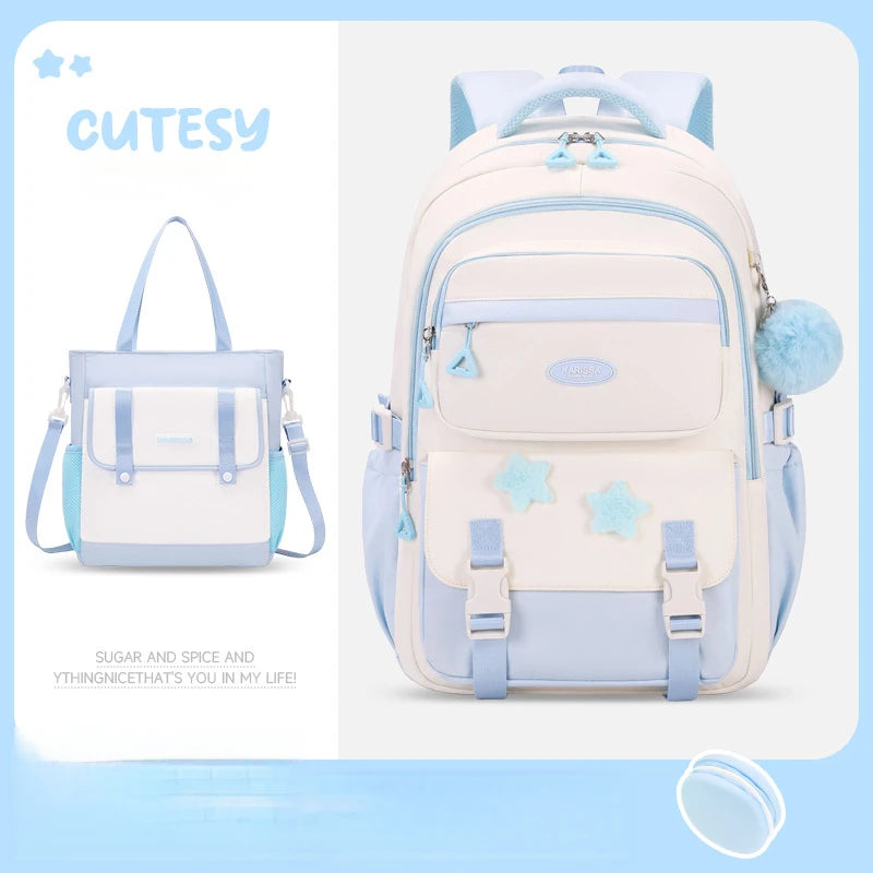 Cutesy white and light blue backpack with snowflake designs on a light blue background.