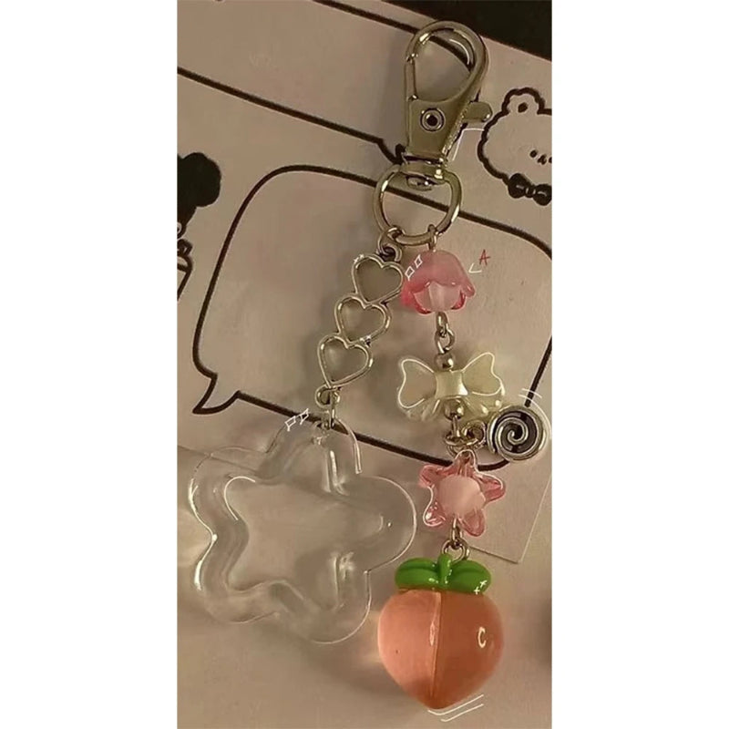 Keychain with star, peach, and butterfly charms on a white background