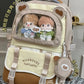 beary cute backpack with bear ears and a visible brand logo, against a white door , brown version