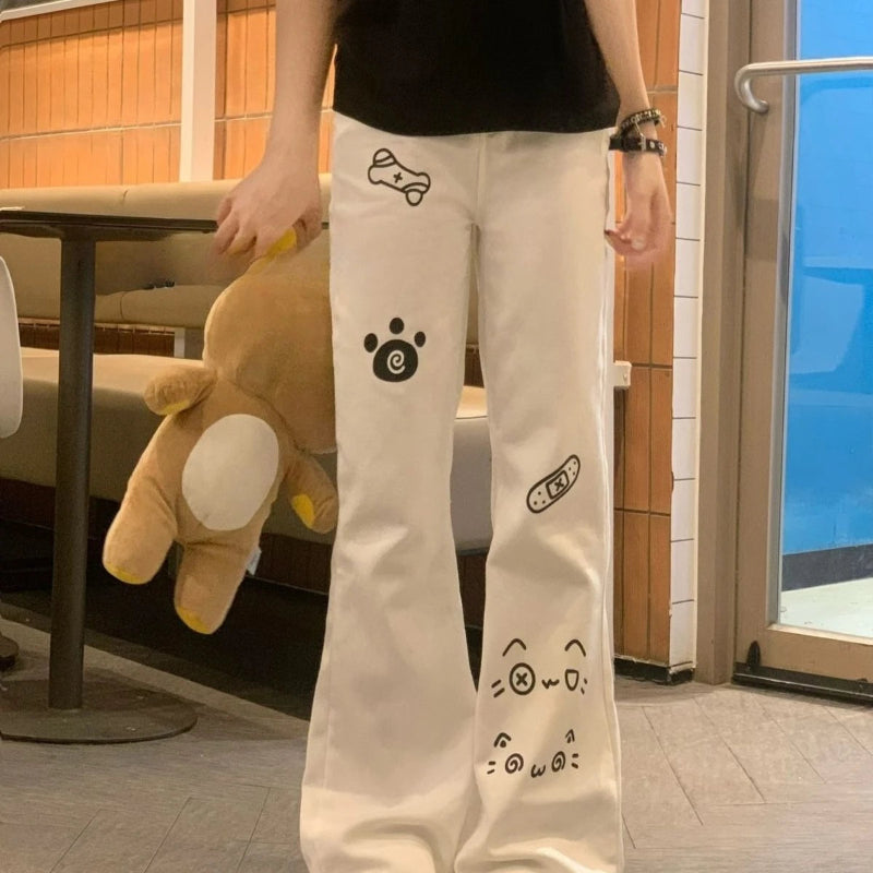 Person wearing white pants with cartoon character designs in an indoor setting.