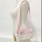 Pink and white kawaii piano bag with a bow on a mannequin against a white background
