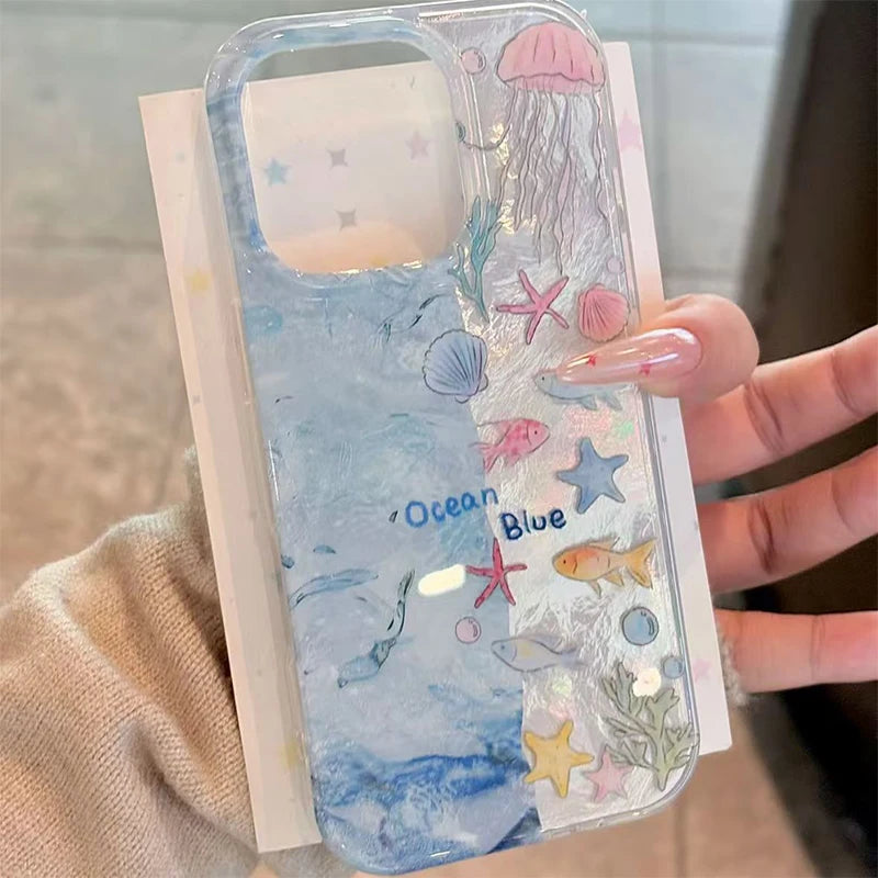 Phone case with ocean-themed design held by a hand