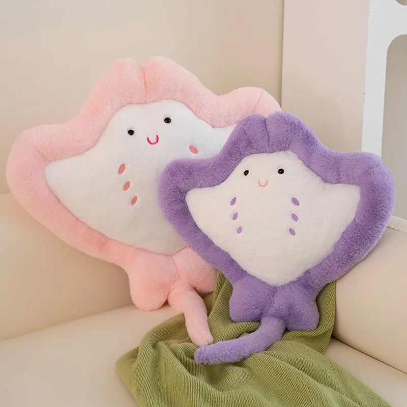 Kawaii manta ray plushies on blanket