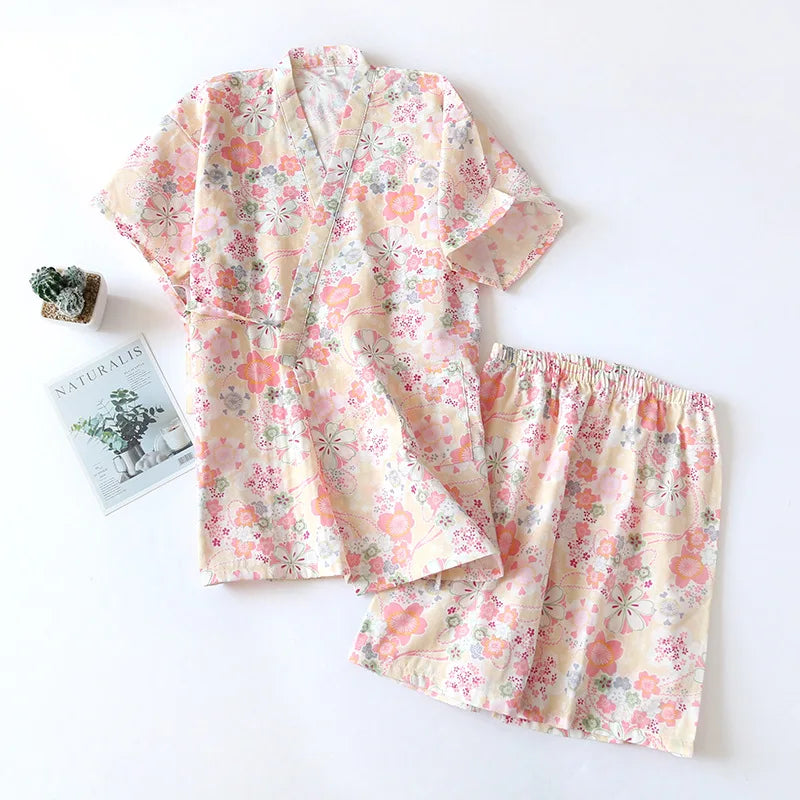 Floral pajama set on a white background with a magazine and plant.