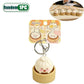 Cute keychain shaped like a dumpling in a wooden container with packaging on a white background.