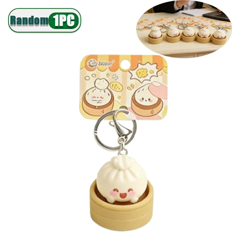 Cute keychain shaped like a dumpling in a wooden container with packaging on a white background.