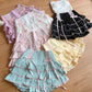 Set of colorful ruffled skirts on a wooden surface