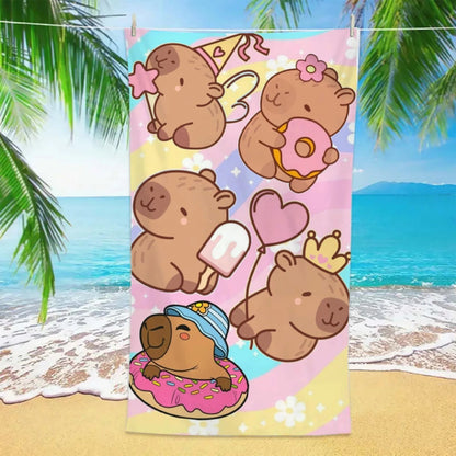 Colorful towel with cartoon cqapybaras on a beach background