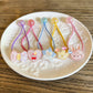 Kawaii hair accessories with various designs on a white plate.
