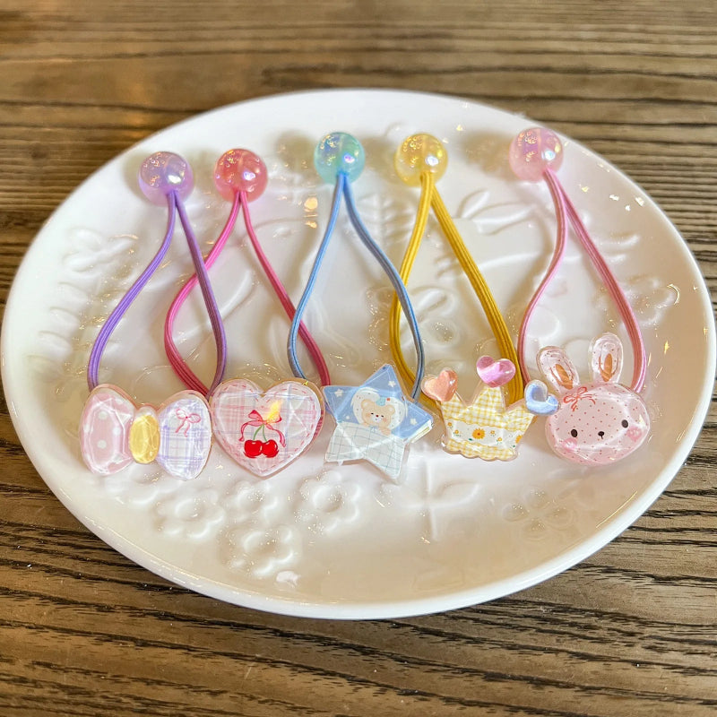 Kawaii hair accessories with various designs on a white plate.