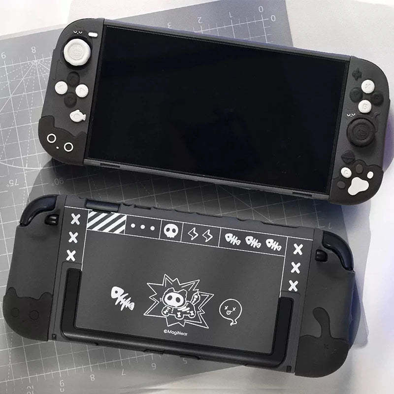 Black handheld gaming console with custom designs on a gray surface