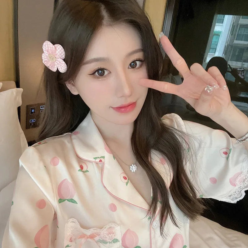 woman posing in the Cute Peach Print Lace Trim Pajamas.
