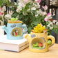 Two decorative planters with small figurines on a wooden surface.