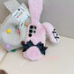  the Kawaii Plush Bunny Samsung Phone Case is being displayed against a white tote bag one bunny ear up and the other down to display how cute and fluffy the case is.