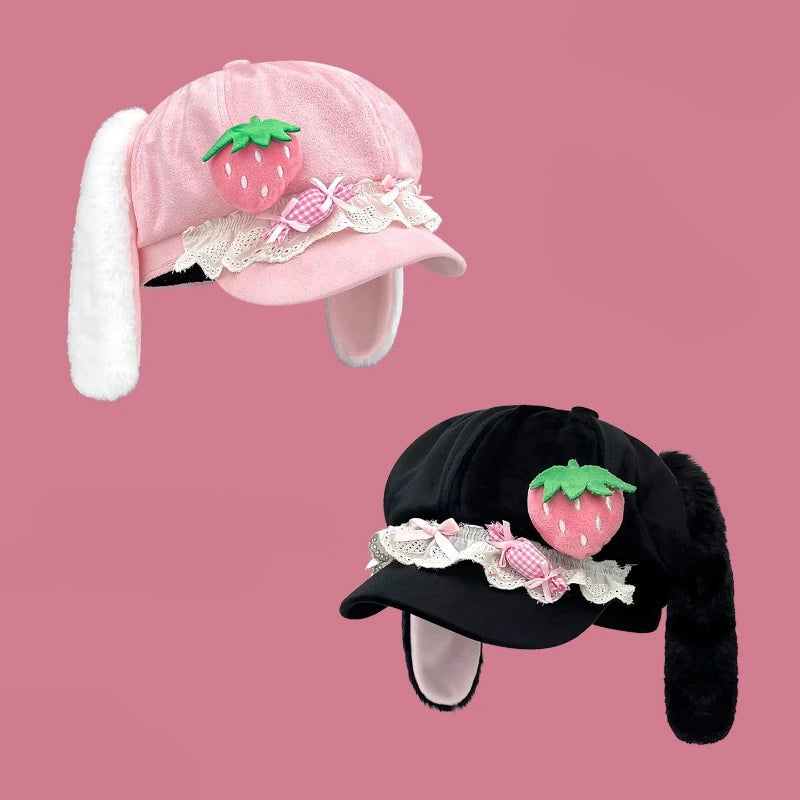 Two kawaii bunny hats with strawberry designs on a pink background.
