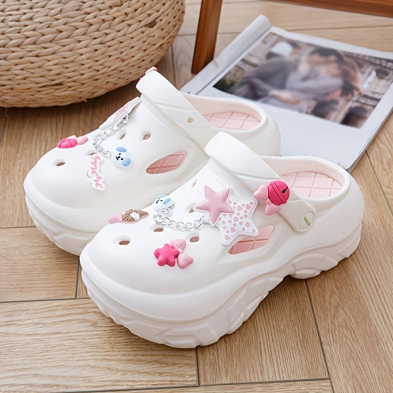 White sandals with stars and bows as decorative charms on a wooden floor