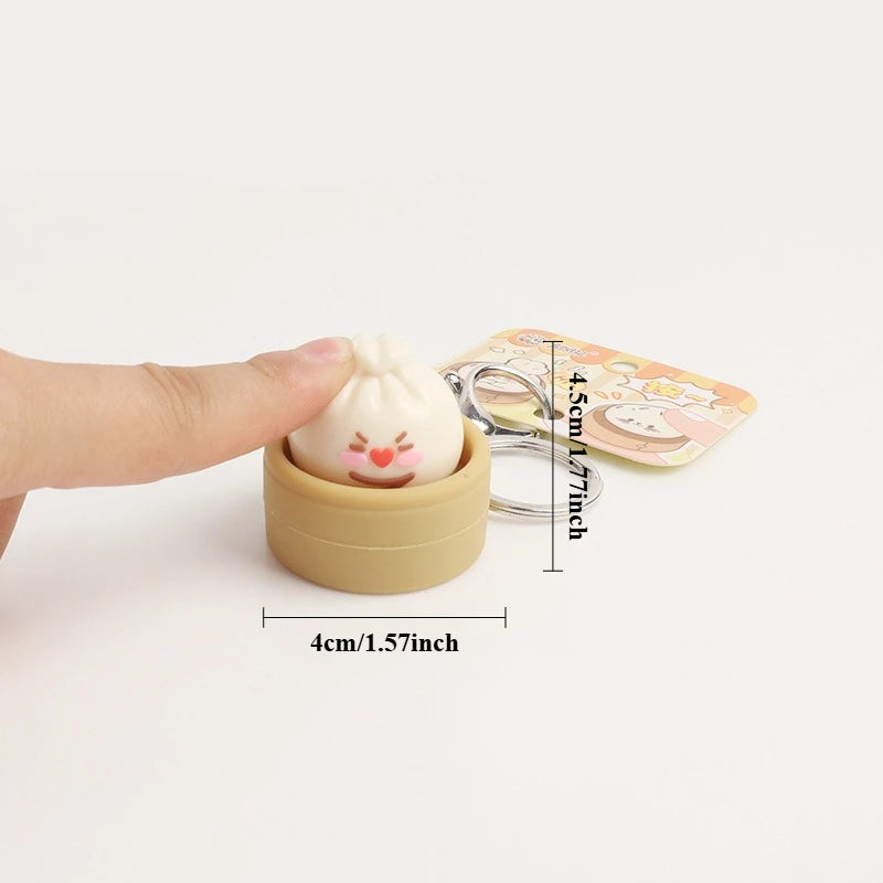 Small sensory toy with a keychain attached, held by a hand, on a white background with measurements indicated.