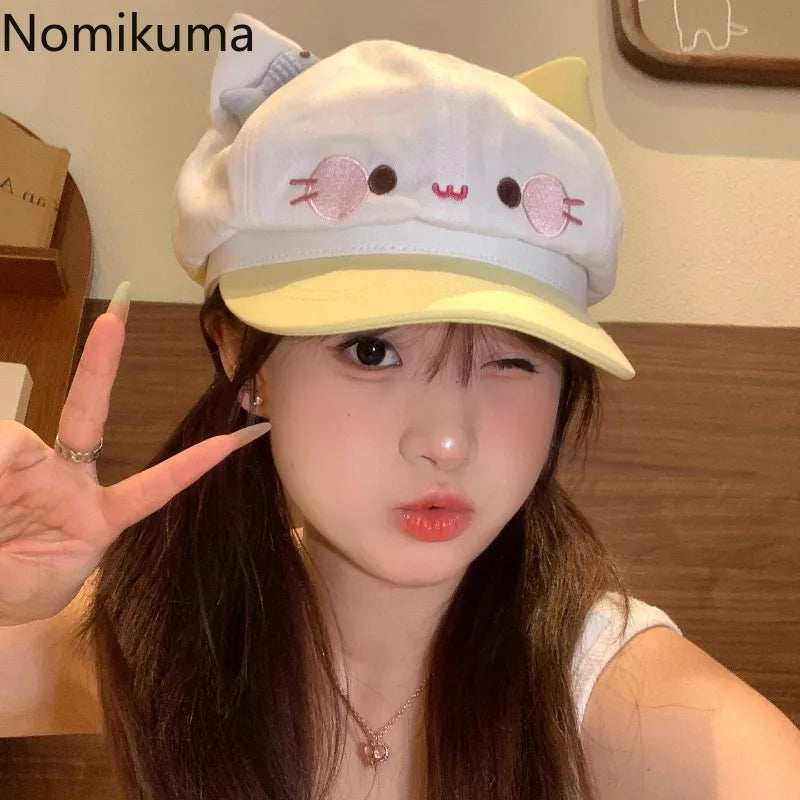 Person wearing a cute hat with cat ears and making a peace sign.