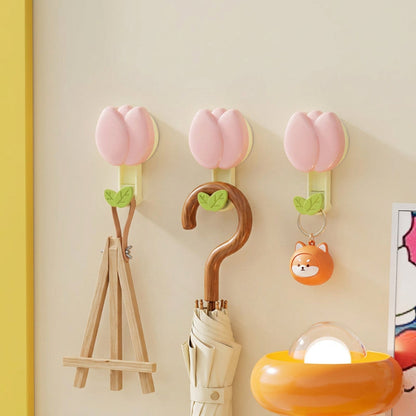 Pink petal hooks on a wall with various items hanging, including an umbrella and a lamp, with 'DOPAMINE Petal hook' branding.
