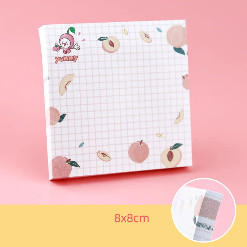 Kawaii sticky notes pad with peach-themed design on a pink background