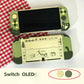 Green gaming console with cartoon design on a white background