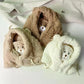 Three kawaii bear-shaped hats in beige, brown, and white on a light background.