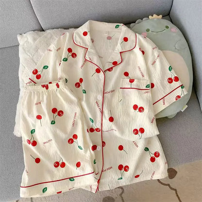 Cute Cherry Print Summer Pajama Set, displayed on a sofa showing top and shorts.