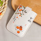White cardholder with orange design on a wooden surface