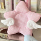 Pink star-shaped coaster with white polka dots and clouds on a shelf.