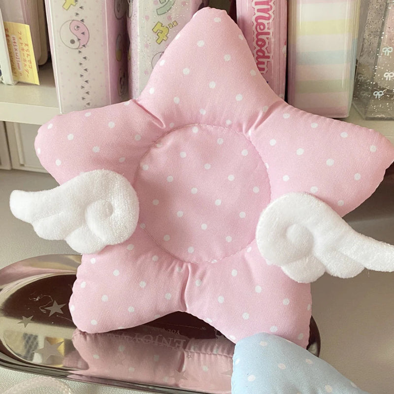Pink star-shaped coaster with white polka dots and clouds on a shelf.