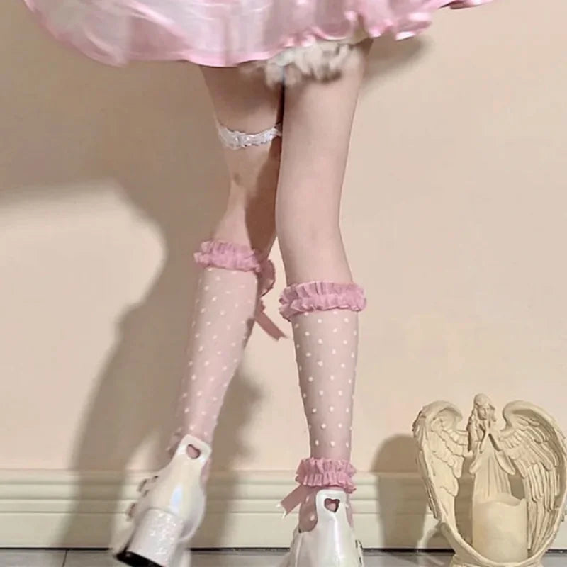 Kawaii back view Polka Dot pink socks modeled by a woman standing next to a wall 