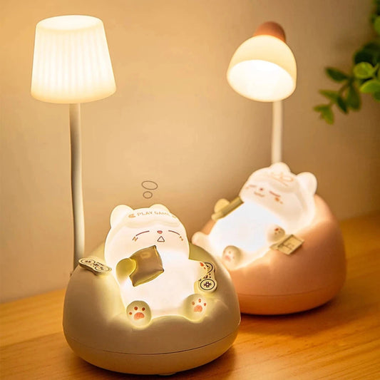 Two kawaii cat night lights on a wooden surface with a soft background.