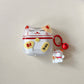 Clear air pod case with a kawaii maneki neko cat design and a matching keychain on a light gray background