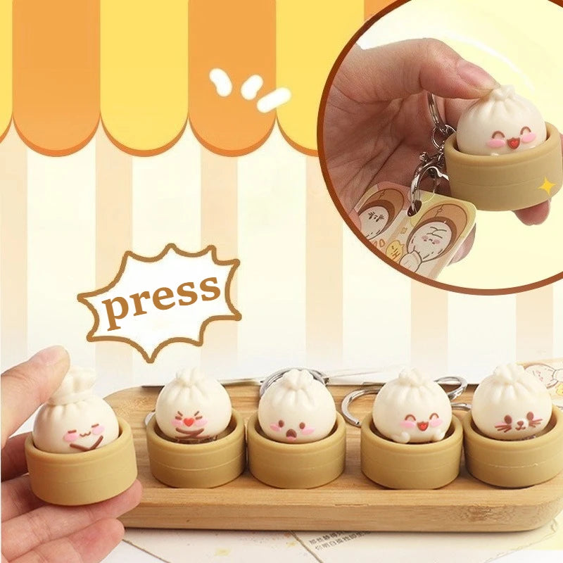 Set of cute keychains shaped like cartoon-style buns in a wooden steamer with a 'press' label.