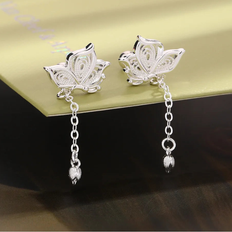 Kawaii Silver Butterfly Stud Earrings displayed on a table 
